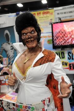 a woman dressed in costume giving the thumbs up