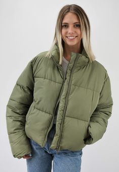 Warm and Fashionable. This cropped puffer jacket adds just the right style to any outfit while keeping you warm. The jacket has a front zipper and pockets to maximize fashion and ease with a back adjustment to cinch the waist for the most flattering fit. Wear this now for those chilly days or on gameday to add just the right color to your outfit. Pairs nicely with Color Fleece Crop. Color-Olive Green (also available in Stone, Blue, Teal, Cheddar Gold, Caramel, Cream, Black, Pale Lavander, Charcoal Blue, Pale Pink, Sky Blue, Hot Pink, Milk Chocolate, Orange, Green, and Lime Green) 80% Polyester 20% Nylon Back Adjustment, Green Puffer Jacket, Cream Outfits, Super Puff, Green Puffer, Travel Buddy, Waist Jacket, Cropped Puffer Jacket, Neck Pillow Travel