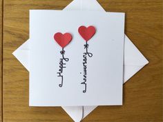 two hearts are attached to the back of a card