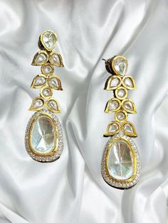 Beautiful uncut polki vintage earrings with gold diamond work and a modern luxurious look for any jewelry lover! The earrings are inspired by the royal princely states of rajasthan and have handwork done with diamond work added for a luxurious look! This lightweight and elegant earring is perfect for any bridesmaid, bride, sangeet or any occasion or event as a gift for any occasion as any one who loves jewelry will love this statement piece. It has beautiful colors that really make the set a statement piece. There are 4 colors available in these earrings and each of them are made with the highest quality stones. Product Details: * Earrings  Ready to Ship and available immediately if you place an order today! Fast Shipping US Customers receive your order within 5-7 business days. This is th Luxury Gold Jhumkas With Stone Work, Luxury Hand Set Bollywood Earrings, Luxury Gold Plated Bridal Earrings With Meenakari, Elegant Gold Chandbalis For Reception, Elegant Meenakari Dangle Danglers, Diwali Reception Chandelier Earrings With Stone Work, Bollywood Earrings With Intricate Design For Reception, Bollywood Style Earrings With Intricate Design For Reception, Kundan Drop Earrings For Reception