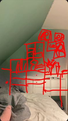 a bed with red graffiti on the wall above it