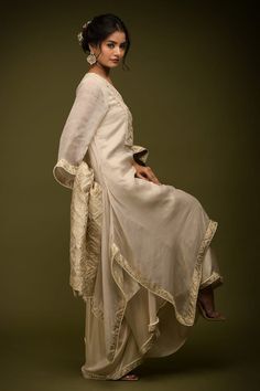 Ivory and beige kurta with cutdana embroidered floral jaal patterns embellished by mirrorwork. Comes with flared pant, inner and dupatta. - Aza Fashions White Chikankari Embroidery Palazzo Set In Raw Silk, Elegant V-neck Anarkali Set With Resham Embroidery, Cream Chikankari Embroidery Anarkali Set In Raw Silk, Elegant Slub Silk Churidar With Intricate Embroidery, Off White Raw Silk Kurta For Reception, Cream Chikankari Anarkali Set In Raw Silk, Cream Slub Silk Traditional Wear For Wedding, Elegant Anarkali Set With Resham Embroidery And V-neck, Elegant Anarkali Set With V-neck And Resham Embroidery