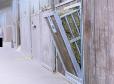 an open barn door with hay in it