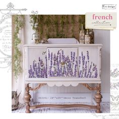 an old dresser with lavender flowers painted on the front and side panels, along with other antique items