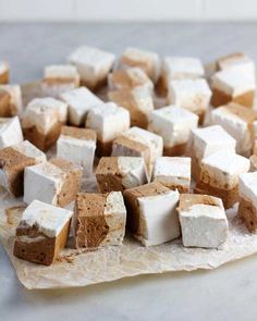 marshmallows sitting on top of a piece of parchment paper