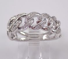 a white gold ring with diamonds in the shape of two intertwined rings on top of each other