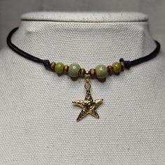 Green Ceramic Beaded Gold Swirl Starfish Charm Boho Hippie Beach Adjustable Black Rope Cord Choker Stacking Necklace Comes On An Adjustable Waxed Black Cord Necklace. Necklace Is Adjustable From Approximately 13" To 22". To Wear Your Necklace Pull The Two Knots Away From The Pendant To Adjust To A Larger Size, Leave About An Inch Of Space Between The Two Knots To Prevent It From Getting Stuck. Put Cord Around Your Neck And Pull The Two Knots In The Opposite Direction To Adjust To A Smaller Size. Adjustable Necklace With Starfish Charm, Adjustable Starfish Charm Jewelry, Star-shaped Colorful Beaded Jewelry For The Beach, Star-shaped Colorful Beads Jewelry For Beach, Bohemian Starfish Beaded Necklaces, Bohemian Beaded Starfish Necklace, Bohemian Beaded Necklaces With Starfish Charm For Gifts, Bohemian Beaded Necklace With Starfish Charm As Gift, Adjustable Star-shaped Jewelry With Starfish Charm