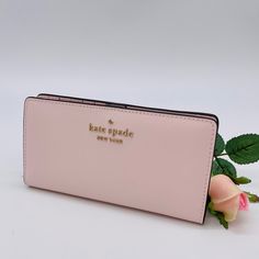 Brand New With Tag Kate Spade Staci Large Slim Bifold Wallet Color: Light Rose Details Saffiano Leather Two Way Spade Jacquard Lining Snap Closure 12 Credit Card Slots Id Window 4 Slip Pockets Zip Compartment On Back Of Wallet Approx. Measurements: 3.5"H X 6.7"W Classic Pink Compact Wallet, Classic Compact Pink Wallet, Feminine Pink Wallets For Daily Use, Pink Feminine Wallet For Everyday Use, Feminine Pink Wallet For Everyday Use, Formal Pink Wallets With Interior Card Slots, Pink Feminine Wallet For Everyday, Trendy Pink Leather Wallets, Pink Rectangular Feminine Wallet