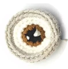 a white and brown rope with a black hole in the center