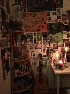 a room filled with lots of pictures and a guitar sitting on top of a table