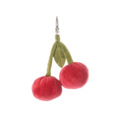 two cherries hanging from a hook on a white background