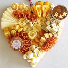 a heart shaped platter filled with different types of food