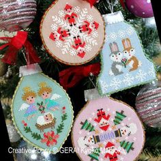 cross stitch ornaments hanging from a christmas tree