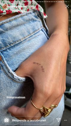 a person with a small tattoo on their left hand and the word love is written in cursive writing