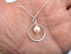 This infinity pearl necklace consists of:  1. a large asymmetric pear-shaped sterling silver infinity charm 2. a freshwater pearl (available in teardrop,coin,and round shape) hung inside the bigger lower loop of the infinity charm 3. a sterling silver chain (several lengths available) closed with a lobster clasp. 4. a personalized note card (customized with your own message, not a boiler plate one), printed on heavy weight cardstock, in elegant font and layout. ALL STERLING SILVER COMPONENTS Pac Pear-shaped Pearl Necklace Gift, Personalized Teardrop Pendant Jewelry For Wedding, Personalized Teardrop Pendant Wedding Jewelry, Personalized Teardrop Pendant For Wedding, Pear-shaped Pearl Drop Necklace As Gift, Sterling Silver Pearl Necklace For Wedding And Mother's Day, Teardrop Necklace For Wedding On Mother's Day, Wedding Teardrop Necklace For Mother's Day, Personalized Teardrop Wedding Necklaces