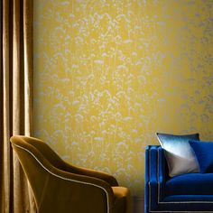 a blue chair sitting in front of a yellow wall