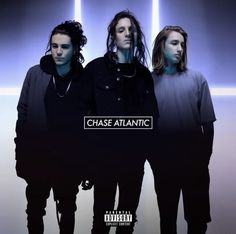 three young men standing in front of a wall with the words chase atlantic on it