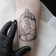 a tattoo on the leg of a person with a message in a glass jar under which is written