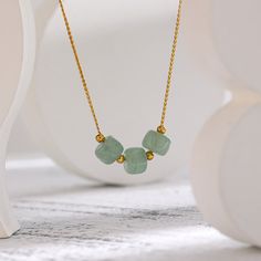 Introducing our gorgeous green aventurine necklace by Asana Crystals! This beautiful piece is 18K gold plated and features three polished natural aventurine stones. Green aventurine is known for its ability to attract abundance, good luck, and prosperity, making it the perfect crystal necklace to wear when you want to manifest your dreams into reality. It's also said to promote self-love, compassion, and empathy, which makes this gemstone necklace not only stylish but also powerful. Whether you' Gold Aventurine Gemstone Necklace, Gold Aventurine Necklace With Gemstone, Gold Aventurine Necklaces For Healing, Spiritual Gold Aventurine Necklace, Spiritual Aventurine Gold Necklace, Green Aventurine Necklace, Aventurine Necklace, Attract Abundance, Aventurine Stone