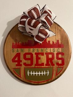 a wooden sign that says san francisco 94ers with footballs on it and the words san francisco