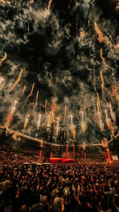 fireworks are lit up in the sky above a crowd