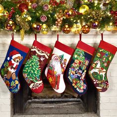 christmas stockings hanging from a fireplace in front of a tree