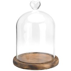 a glass clochet with wooden base and a heart on the top for decoration