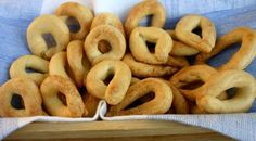 a pile of bagels sitting on top of a blue cloth