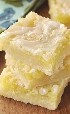 three pieces of cake sitting on top of a wooden table