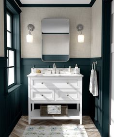 a bathroom with green walls and white vanity in the center, along with two mirrors