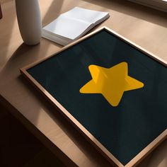 a wooden table with a yellow star cut out in the middle and a white vase next to it