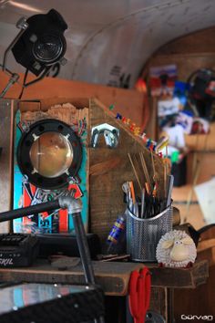 the inside of a vehicle with tools and other items on it's desk area