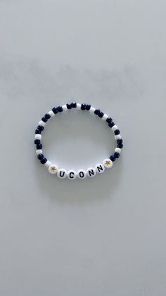 Show your school pride and complete your game day outfit with a custom navy blue and white beaded bracelet for the University of Connecticut! Blue Beaded Bracelets With Letter Beads For Team Spirit, Casual Blue Jewelry For Game Day, Blue Team Spirit Jewelry For Game Day, Personalized Blue Bracelets For Game Day, Casual Blue Customizable Beaded Bracelets, Casual White Stretch Bracelet For Game Day, Casual Blue Customizable Name Bracelet, Customizable Casual Blue Jewelry, Casual Customizable Blue Jewelry