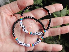 These Pride Bracelets are ideal for stacking with other bracelets. Each bracelet is made with dainty 4mm hematite (metallic looking) or black agate stones, plus rainbow beads and alphabet beads with your choice of message. Pride isn’t one size fits all—so Josie has created these bracelets with a variety of pride-themed sayings. Features: Genuine Hematite stacking bracelet with LGBT+ Pride sayings Customizable (Maximum 8 characters) Threaded on a strong elastic string material Looking for something that subtly makes your pronouns known, or shows your pride to the world? Look no further than these gorgeous handmade bracelets. Hematite and black agate are both known as very grounding stones, which we could all use a little more of when Pride month comes around. They help to ward off all sorts Pride Sayings, Ibd Awareness, Pride Bracelets, Lgbt Bracelet, Grounding Stones, Black Agate Stone, Intention Bracelets, Awareness Jewelry, Pride Bracelet