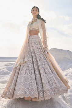 This nude net lehenga set features ivory thread, sequin, and pearl embroidery. The plunging neckline shows pearls along the v neck. The sleeves of the blouse have pearl tassels at the hem. The dupatta has a scalloped border on all four sides.From Seema Gujral's Elements collection. DELIVERY TIMEPlease allow 6-8 weeks for your outfit to arrive. FABRIC DETAILSNet Professional cleaning only. Ivory Lehenga Bridal, Reception Lengha, Ivory Lehenga, Pearl Tassels, Pearl Embroidery, Scalloped Border, Net Lehenga, Pearl Details, Desi Style