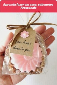 a hand holding a packaged cookie with a tag on it's side and the words from any's shower to yours