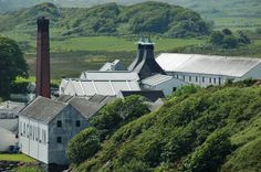 an old factory on the side of a hill