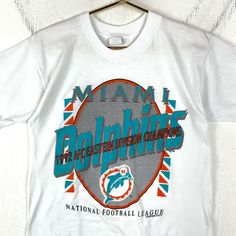 Vintage Miami Dolphins T-shirt Large 1992 Afc Champs Nfl Single Stitch 90s Size/Measurements (Based in inches) Size - Large Pit to pit - 19.5" Length - 27" Condition / Details Light stains on front Combined Shipping: We provide combined shipping, please contact us for a quote Vintage Miami, Miami Dolphins, Mens T Shirts, Light Stain, Dolphins, Miami, Nfl, Mens T, Tee Shirts