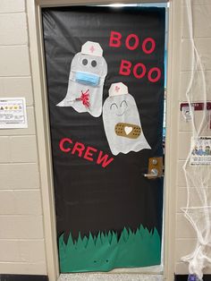 a door decorated for halloween with two ghostes and the words boo boo crew on it