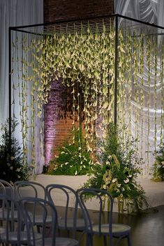 Unique wedding chuppah adorned with hanging orchids, adding a touch of romance and elegance. Huppah Wedding Indoor, Unique Chuppah, Hanging Floral Backdrop, Chuppah Design, Modern Chuppah, Huppah Wedding, Chuppah Ideas, Floral Chuppah, Wedding Planning Packages