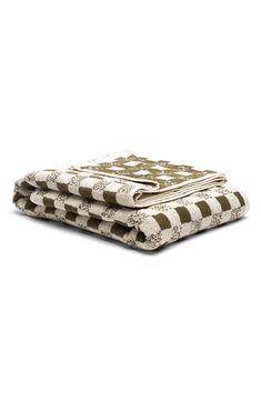 three towels stacked on top of each other in front of a white background with black and white designs