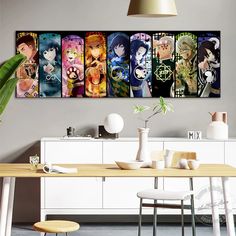 a room with a table, chairs and pictures on the wall above it that have anime characters painted on them