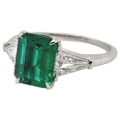 Breathtaking handmade emerald and diamond engagement ring. Set in platinum. Centered with an AGL (American Gemological Laboratories) certified natural emerald-cut emerald that weighs 1.60 carats. This magnificent deep saturated color is natural to the Emerald. The AGL report states there is no gemological evidence of heat. The center emerald is accentuated by two matched custom 'Baguette' Cut diamonds that weigh approximately 0.72 carats total. Accompanied with individual GIA (Gemological Institute of America) reports with graded G color with VS1-VS2 clarity. This beautiful ring is currently size 6, and it can easily be custom sized. An elegant classic piece of jewelry. Alice Kwartler has sold the finest antique gold and diamond jewelry and silver for over forty years. Emerald And Diamond Ring, Platinum Diamond Rings, Emerald Diamond Ring, Emerald Engagement, Emerald Engagement Ring, Van Cleef Arpels, Three Stone Rings, Van Cleef, Emerald Diamond