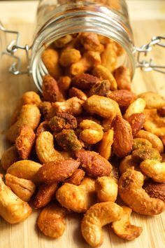 a jar filled with nuts sitting on top of a wooden table