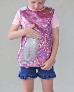 This fun, reversible sequined shirt is your fashion girls staple for the spring or summer! The cotton back provides breathable comfort, while the colorful reverse side is sequined flippin' fun!Front: 100% polyesterBack: 100% cottonHand wash; hang dry Summer Sequins T-shirt, Casual Pink Sequined T-shirt, Sequin Tshirt, Pink Glitter Print Short Sleeve T-shirt, Cheap Cotton Sequined T-shirt, Pink Glitter Print Cotton T-shirt, Sequin Mask, Sequin Pants, Sequin Shirt