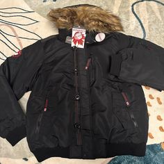 Canada Weather Gear Insulated Flight Jacket Size Large New Never Worn Black Winter Outerwear With Fleece Lining, Black Hooded Outerwear For Cold Weather, Casual Winter Sport Coat With Padded Collar, Black Outdoor Outerwear For Fall, Urban Outerwear With Padded Collar For Cold Weather, Black Double-lined Hooded Outerwear For Fall, Black Urban Outerwear With Detachable Hood, Black Outerwear With Double-lined Hood For Fall, Black Fall Outerwear With Double-lined Hood