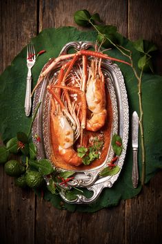 lobsters are cooked and garnished with parsley on a silver platter