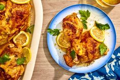 chicken with lemons and parsley on a blue plate