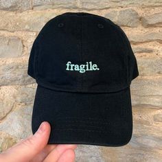 Inject a touch of personalised flair into your ensemble with our Embroidered Small Word Dad Cap - Customisable. This versatile cap allows you to choose any word, name, or small slogan to be tastefully embroidered on the front, creating a unique accessory that truly reflects your individuality. With two cap styles and a wide range of colour options, you can customise your cap to perfectly match your style. Cap Styles:     Vintage Canvas Cap:         Colourways available: Black, Light Denim, Dark Denim, Olive, Stone, Sand, Red, Pink, Cornflower, Bottle Green.         Classic and durable canvas material for a timeless look.         Perfect for adding a touch of vintage charm to any outfit.     Classic Cotton 'Dad' Cap:         Colourways available: Beige, Black, Navy, Mint Green, Pink, Pale B Black Embroidered Cotton Trucker Hat, Cotton Dad Hat With Letter Embroidery And Flat Bill, Cotton Trucker Hat With Letter Embroidery And Curved Visor, Adjustable Black Trucker Hat With Letter Embroidery, Black Cotton Hat With Letter Embroidery, Black Cotton Dad Hat With Letter Embroidery, Cotton Snapback Hat With Letter Embroidery, Cotton Snapback Hat With Letter Embroidery And Flat Bill, Adjustable Cotton Baseball Cap With Embroidered Text