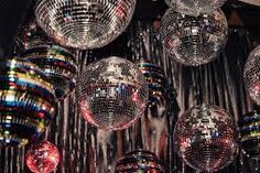 many disco balls hanging from the ceiling in front of a mirror ball chandelier